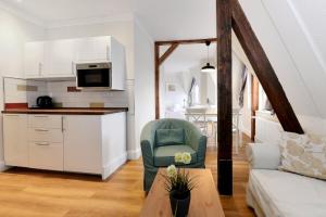 a living room with a couch and a table at Hotel Stralsund in Stralsund