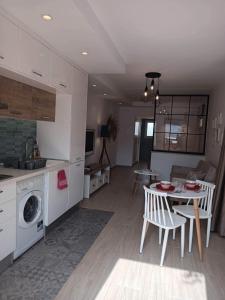 a kitchen and living room with a table and chairs at Marsa BiBi in La Marsa