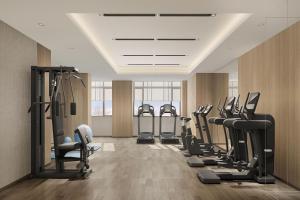 a gym with a row of treadmills and machines at Fairfield by Marriott Danyang in Danyang
