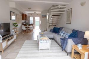 a living room with a couch and a table at Beachfront Accommodation in Port Alfred