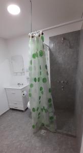 a shower curtain is hanging in a bathroom at M&M ll in Comodoro Rivadavia