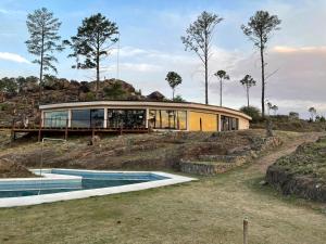 a house on a hill with two swimming pools at Ayllupelli in Villa Berna