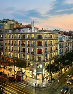 a large white building on a city street at night at Le Palace Hotel in Thessaloniki