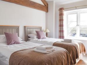 two beds sitting next to each other in a bedroom at Apple Tree Barn- Uk40791 in Church Minshull