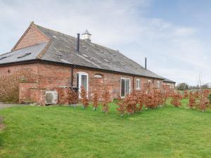 an old brick house with trees in front of it at Apple Tree Barn- Uk40791 in Church Minshull