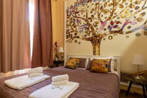 ein Schlafzimmer mit einem Baumbild an der Wand in der Unterkunft Central City Genova in Genua