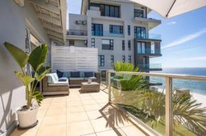 an apartment balcony with a view of the ocean at The Villa Umdloti in Umdloti