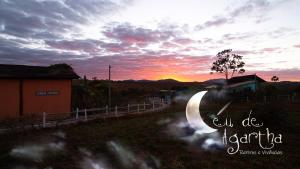 una puesta de sol sobre un camino con las palabras cuota nicaragua en CÉU DE AGARTHA Retiros e Vivências, en Alto Paraíso de Goiás
