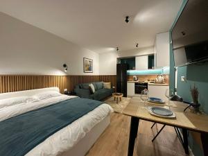 a bedroom with a bed and a table and a couch at Studio in Tirana in Tirana