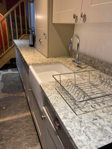 a kitchen counter with a sink and a sink at Maes Madog Cottages in Betws-y-coed +58 photos