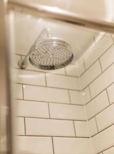 a metal strainer on a wall in a bathroom at New - Bright - Fresh - with Parking in Bath