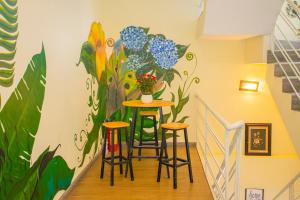 a hallway with a mural of flowers on the wall at Big Home Dalat in Da Lat