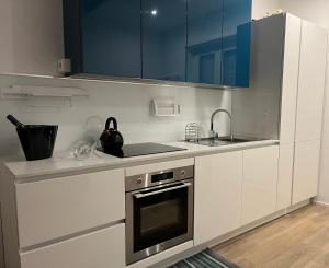 a kitchen with white cabinets and a sink and a stove at Interno 4 - Luxury Holiday Rome in Rome