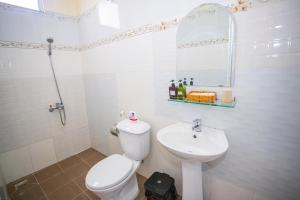 a white bathroom with a toilet and a sink at Big Home Dalat in Da Lat +107 photos