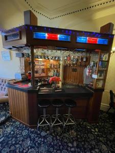 un bar con taburetes en una habitación de hotel en Nevele en Blackpool