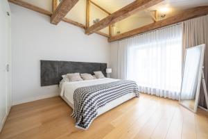 a bedroom with a bed and a large window at Uus 30 Apartments in Tallinn