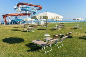 a group of chairs and an amusement park with a roller coaster at Bonaca in Izola