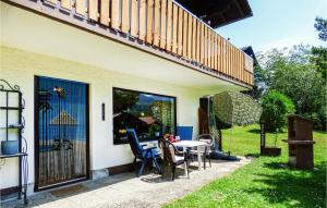 a patio with a table and chairs next to a house at 2 Bedroom Cozy Apartment In Arrach in Arrach