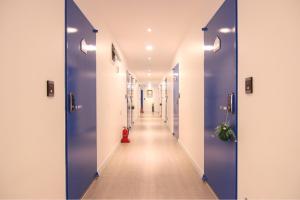 a corridor of a hospital hallway with blue doors at Stay in Blue in Seoul