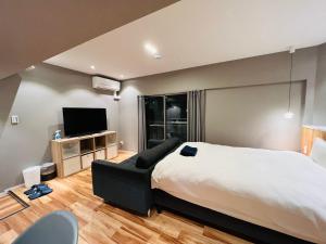 a hotel room with a bed and a television at ZDT-511 in Tokyo