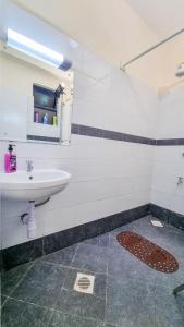 a bathroom with a sink and a mirror at Luxury 1Br Apartment with Secure Parking & Lift Nakuru in Nakuru