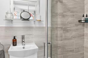 a bathroom with a sink and a shower at Cherwood Guest House in Paignton +145 photos