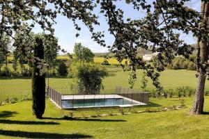 a house with a swimming pool in a field at La Torre del Dr. Pont. Nature and entertainment. in Sant Boi de Lluçanès