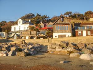 a group of houses on a hill with rocks at 1 Tulse Hill Cottages in Ventnor