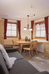 a living room with a table and chairs at Chalet Winklwiese in Valdaora