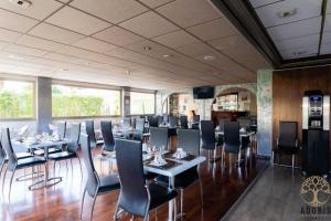 a restaurant with tables and chairs in a room at Adonis Cannes - Hôtel Thomas in Le Cannet