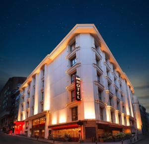 Jaff Hotels & Spa Nisantasi في إسطنبول: مبنى ابيض عليه لافته جانبيه