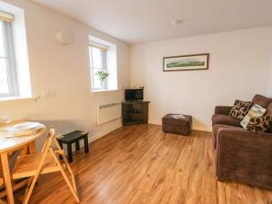 a living room with a couch and a table at Tides Reach in Newton Stewart