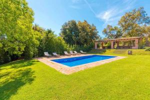 un patio trasero con piscina y cenador en Masia 1612 Muy cerca de las playas Costa Brava, en Calonge