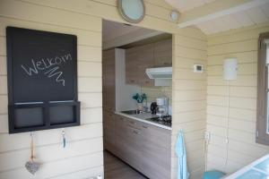 a kitchen in a tiny house with a chalkboard on the wall at Oud Drimmelen in Drimmelen