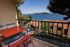 a balcony with a table and chairs and a view of the water at Amadria Park Camping Trogir - Apartments in Seget Vranjica