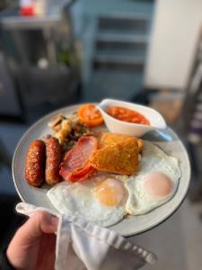 a plate of breakfast food with eggs and other foods at Royal George in Great Easton