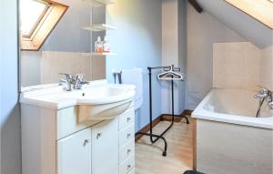 a bathroom with a sink and a bath tub at Amazing Home In Bonneville-La-Louvet in Bonneville-la-Louvet +31 photos