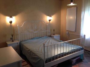 a bedroom with a bed with two tables and two lights at Holiday home in Zalaistvand 27940 in ZalaistvÃ¡nd