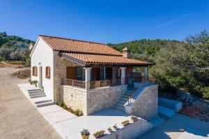 a small house with a terrace and a roof at Holiday Home Irena-Adriatic Luxury Villas in Žman