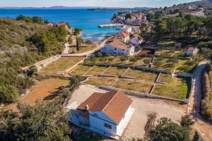 an aerial view of a house on a hill next to the ocean at Holiday Home Irena-Adriatic Luxury Villas in Žman