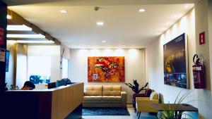 a lobby with a reception desk and a couch at HOTEL BRASIL in Boa Esperança