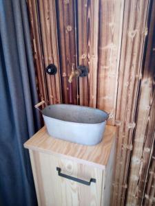 a bathroom with a sink on top of a wooden cabinet at Tiny House Calido in Apelern