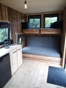 an inside view of an rv with a couch and windows at Tiny House Calido in Apelern