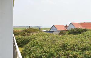 a row of houses on a hill with bushes and flowers at Cozy Apartment In Ringkøbing in Ringkøbing