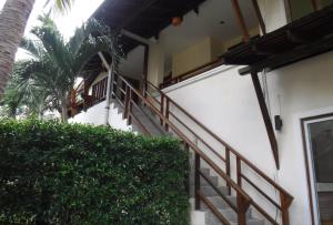 a staircase leading up to a building with a palm tree at Seashell Resort Koh Tao-SHA Plus in Koh Tao