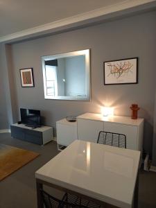 a living room with a white table and a mirror at Heart of the city. Perfect for attractions & West End in London