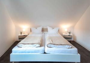 two beds in a small room with two lamps at K05 Fischerkaten LENI max 3 Pers in Dorf Körkwitz