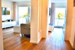 a living room with wood floors and a living room with a couch at Buhne 10 App Nr 26 max 2 Pers in Dierhagen