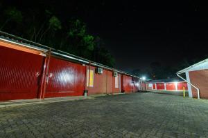 a row of red brick buildings at night at Motel Kaskata in Santa Cruz do Sul