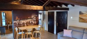 a living room with a table and chairs and a couch at Casas Recuero in Chinchón +15 photos